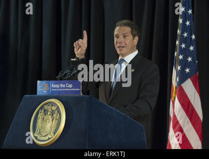 Seaford, New York, USA. 3rd June, 2015. New York State Governor ANDREW CUOMO speaks at an event in support of extending the NY Property Tax Cap. At the bi-partisan event at Knights of Columbus Hall, over a hundred area residents and officials urged an extension of the property tax cap before the state legislative session ends on June 17. The NY Property Tax Cap is set to expire June 2016, but is legally linked to NYC rent-control regulations set to expire this month. In June 2011 in Nassau County, the governor signed the first property tax cap law. Podium has The Great Seal of New Yo Stock Photo