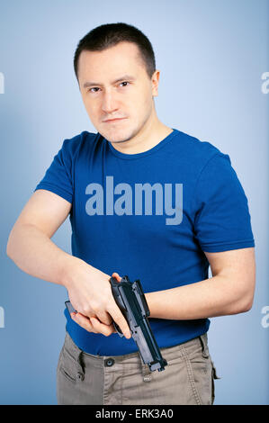 Confident man holding handgun Stock Photo