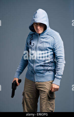 Aggressive young man with gun. Stock Photo