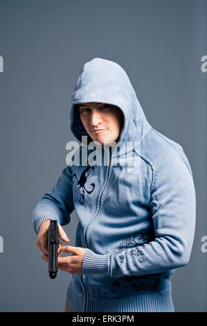 Aggressive young man with gun. Stock Photo