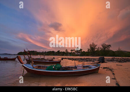 Longtail boats at sunset on Koh Lanta, Thailand Stock Photo