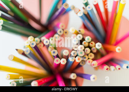 Overhead view of multicolored coloring pencils in pots Stock Photo