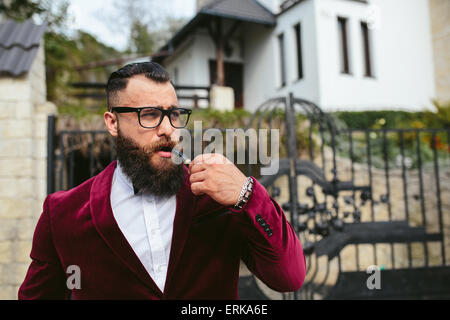rich man in a jacket near his house Stock Photo