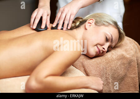 close up of woman having hot stone massage in spa Stock Photo