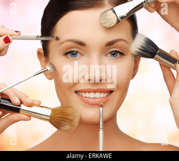 happy woman applying professional make-up Stock Photo