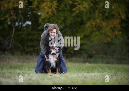 woman with Bernese Mountain Dog Stock Photo