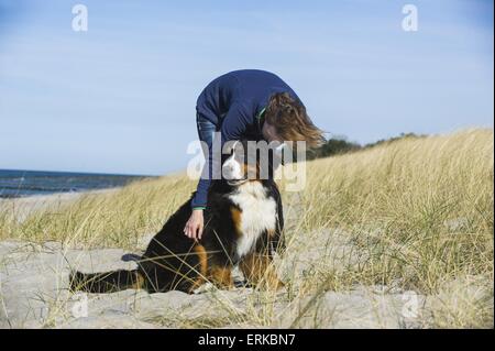 woman with Bernese Mountain Dog Stock Photo
