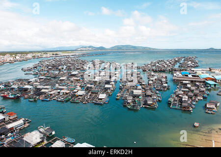 Fishing boats and fish farms in the sea by Monkey Island, Hainan Province, China Stock Photo