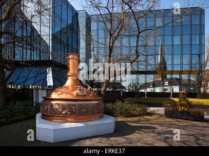 Brewing kettle in front of the administration of the Warsteiner Brewery, reflection of the Church of St. Pancras, Warstein Stock Photo