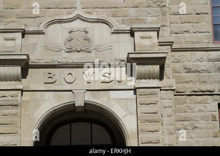 Sandstone school building with separate boys and girls entrances Stock Photo