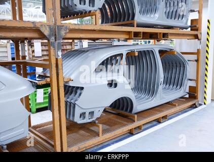 Sheet metal stamped parts for the new car in the car factory. Stock Photo