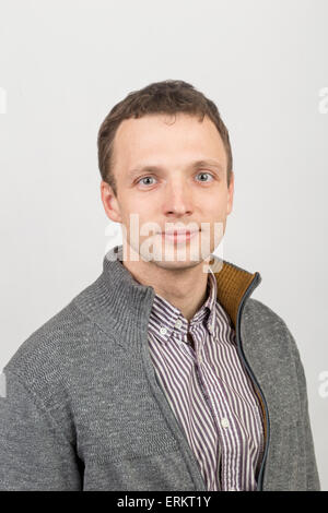 Young smiling Caucasian man in casual clothing, studio portrait over white background Stock Photo