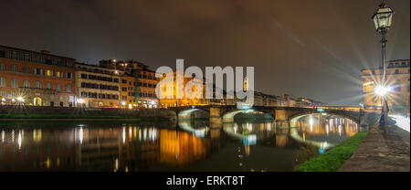 FLORENCE, ITALY - March 21, 2014: long exposure at night of river Arno, Ponte Vecchio and city skyline in  Florence, Italy. Stock Photo