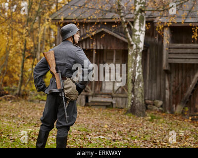 Historic costume theme World War II, Finnish soldier and Submachine-gun Finland m/31 SJR (muzzle brake version). Stock Photo