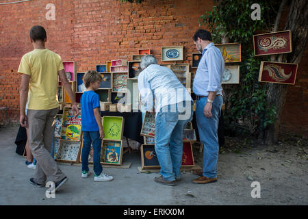 People looking at homemade picture frames on a stall at the LX Factory Lisbon Stock Photo