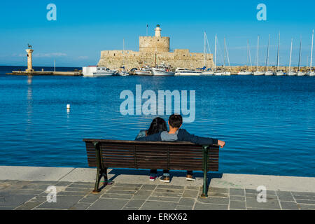 The old Agios Nikolaos fortress and lighthouse in Mandraki Harbour, Rhodes Town, Rhodes, Dodecanese Islands, Greek Islands Stock Photo