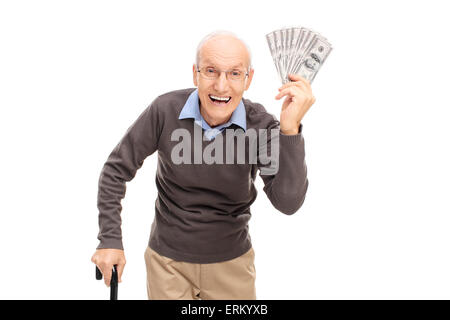Studio shot of a joyful senior holding a stack of money and  looking at the camera isolated on white background Stock Photo
