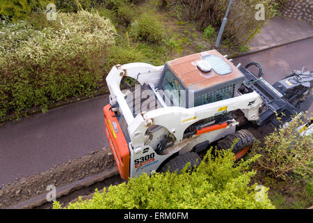 Trench digger trenching in preparation for high speed fiber internet installation in residential area  Model Release: No.  Property Release: No. Stock Photo