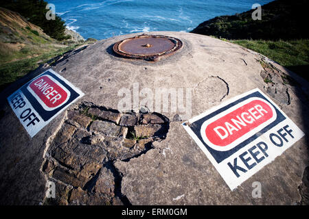 Danger, Keep Off sign on buried concrete defensive structure, California. Stock Photo