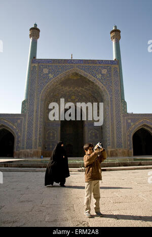 Young Iranian tourist filming in Imam mosque in Esfahan, Iran. Stock Photo