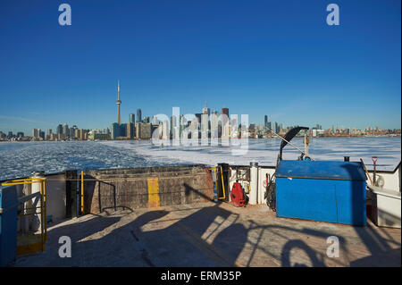 Ferry moving threw breaking ice in harbor waterfront; Toronto, Ontario, Canada Stock Photo