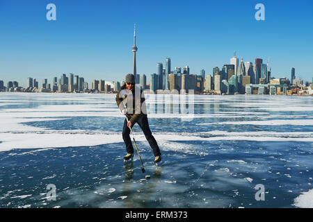 Hockey player and city skyline from Ward's Island; Toronto, Ontario, Canada Stock Photo