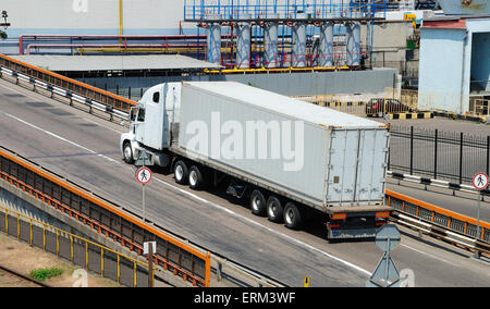 Transportation of cargoes in containers by lorry Stock Photo