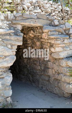Entrance archway to Mayan ruins in the stone wall surrounding Tulum archaeological site on the Caribbean coast of Yucatan, Mexico Stock Photo