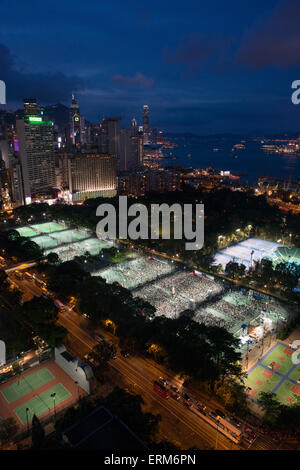 Hong Kong, China. 04th June, 2015. People sit together as they commemorate China's 1989 Tiananmen Square incident during a candlelight vigil in Hong Kong on June 4, 2015. Tens of thousands of people took part in the event to commemorate the 26th anniversary of the bloody Tiananmen Square crackdown, as China attempts to forget the incident. Credit:  Antony Dickson/Alamy Live News Stock Photo