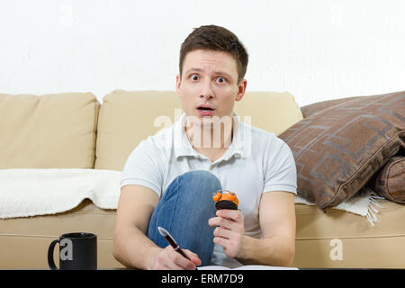Surprised man running out of time looking at watch in a hurry , Time is money concept Stock Photo