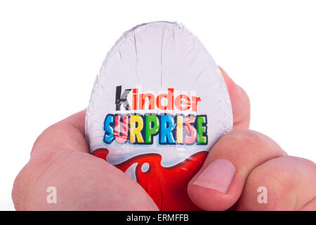 ISTANBUL, TURKEY - MARCH 8, 2015 : Kinder Surprise, chocolate egg holding on hand with a small toy inside, manufactured by Ferre Stock Photo