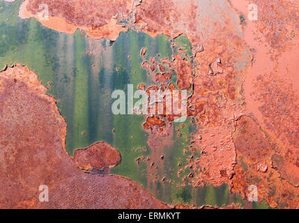 Abstract patterns on a rusty abandoned car surface with colorful patterns. Stock Photo