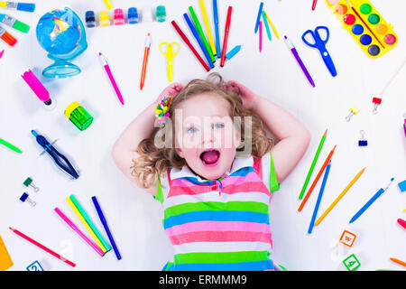 Child with draw and paint supplies. Kids happy to go back to school. Preschool kid learning and studying. Stock Photo