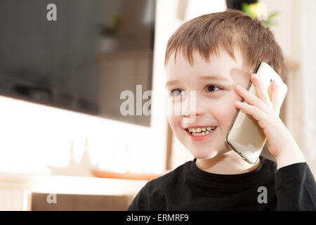 Cute little baby boy is talking on cell phone Stock Photo