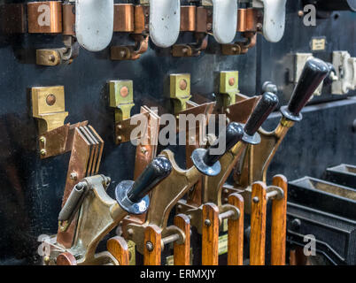 Old industrial copper and wood electrical point levers. Stock Photo