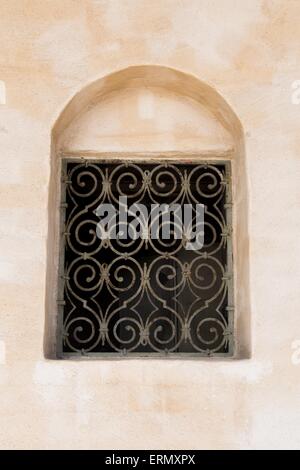 A Dark Window With Metallic Bars in Front Stock Photo