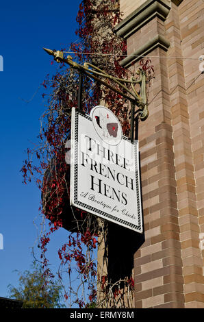 Sign for 'Three French Hens' boutique for women on the side of a historic building in downtown Fairhaven Bellingham Washington Stock Photo