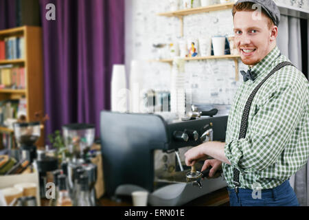 Young barista working in cafe Stock Photo