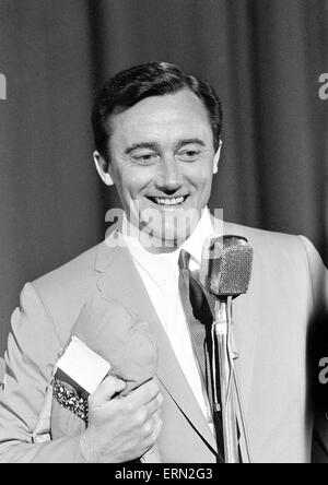 Robert Vaughn, actor who plays the role of secret agent Napoleon Solo in NBC show The Man from U.N.C.L.E., news press conference, Empire Theatre, Leicester Square, London, 22nd March 1966. UK Promotion Tour. Pictured holding cuddly toy received from fan.