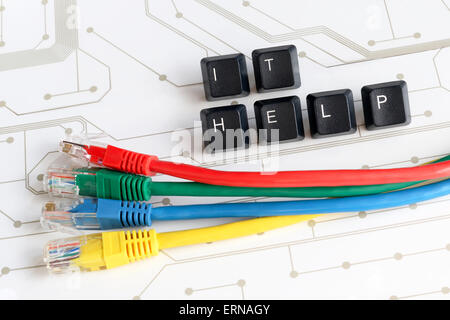 IT HELP, Assistance - Word IT HELP made of keyboard keys with colourful network cables on white circuit board background Stock Photo