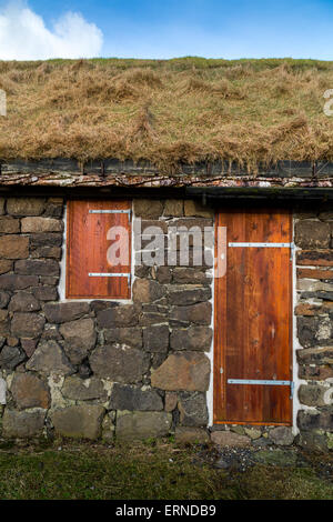 Facade of a typical rural building with natural grass roof and silver birch rafters in Torshavn, Faroe Islands Stock Photo