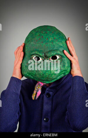 Creepy bald lizard man wearing a blue sweater Stock Photo