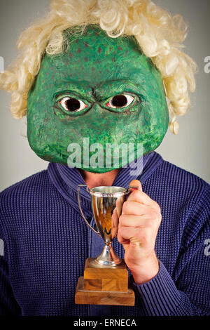 Creepy bald lizard man wearing a blue sweater Stock Photo