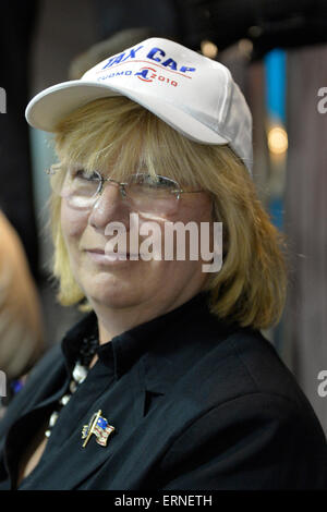 Seaford, New York, USA. 3rd June 2015. CLAUDIA BORECKY, of Merrick, the Democratic candidate for Legislator of Nassau County Legislature District 19, wears a cap with TAX CAP CUOMO 2010 written on it at Press Conference supporting extension of the NY Property Tax Cap. At the bi-partisan event at Knights of Columbus Hall, over a hundred area residents and officials, and the governor, urged extending the property tax cap before the state legislative session ends on June 17. Credit:  Ann E Parry/Alamy Live News Stock Photo