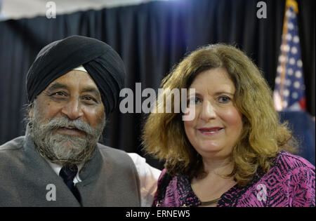 Seaford, New York, USA. 3rd June 2015. MOHINDER SINGH TANEJA of Salisbury, a Sikh and Indian community advocate, and MARIA BRENNAN of Wantagh, pose for a photo at Press Conference supporting extension of  NY Property Tax Cap. Earlier, BRENNAN introduced Governor after she spoke to audience about how, prior to tax cap, her taxes increased 10% in one year, and how high taxes concern family members she'd like to join her in Long Island. At the bi-partisan event, over a hundred area residents and officials, and governor, urged extending the property tax cap. Credit:  Ann E Parry/Alamy Live News Stock Photo