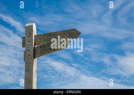 A public footpath signpost against a blue sky Stock Photo