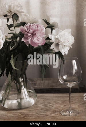 Artwork in retro painting style, Peonies in the glass vase, wine glass Stock Photo