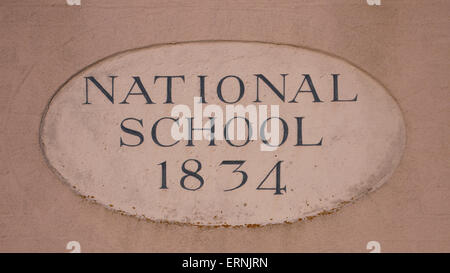A sign on a house in Bosham for a late Georgian school Stock Photo