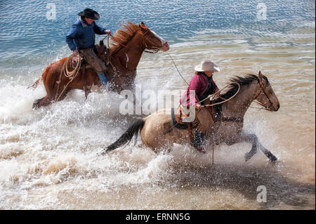 Wranglers at Sombreo Ranch Crossing Water on Horseback, Colorado Stock Photo