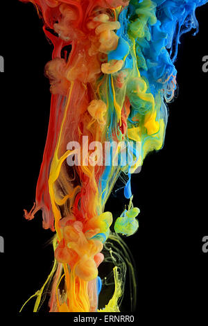 Colorful ink swirling through water Stock Photo